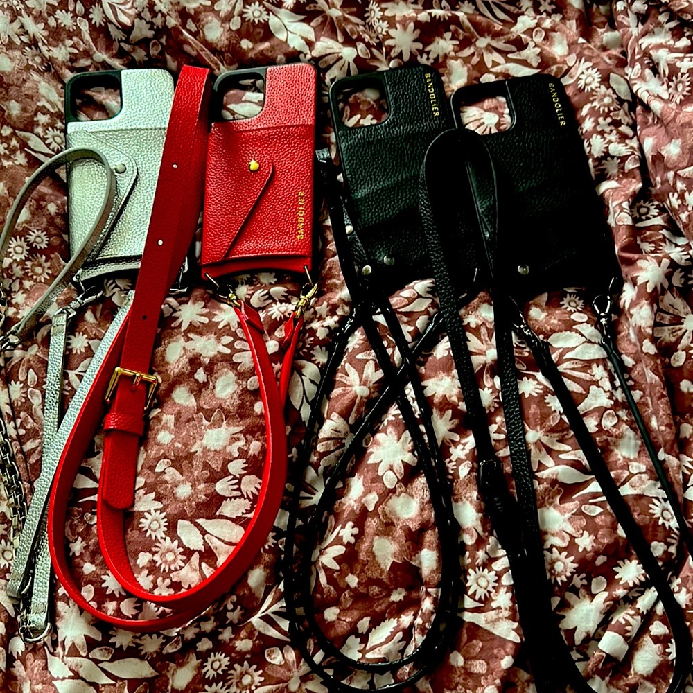 4 Bandoliers iPhone 12 Pro Max cases. A red, a silver and two black.